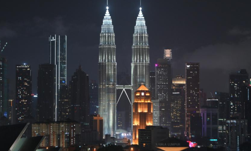This photo taken on March 25, 2023 shows the Petronas Twin Towers before the Earth Hour event in Kuala Lumpur, Malaysia. Earth Hour is a worldwide movement organized by the World Wildlife Fund. The event is held annually, encouraging individuals, communities, and businesses to turn off non-essential electric lights, for one hour, from 8:30 p.m. to 9:30 p.m. on the Saturday of March, as a symbol of commitment to the planet. (Photo by Chong Voon Chung/Xinhua)