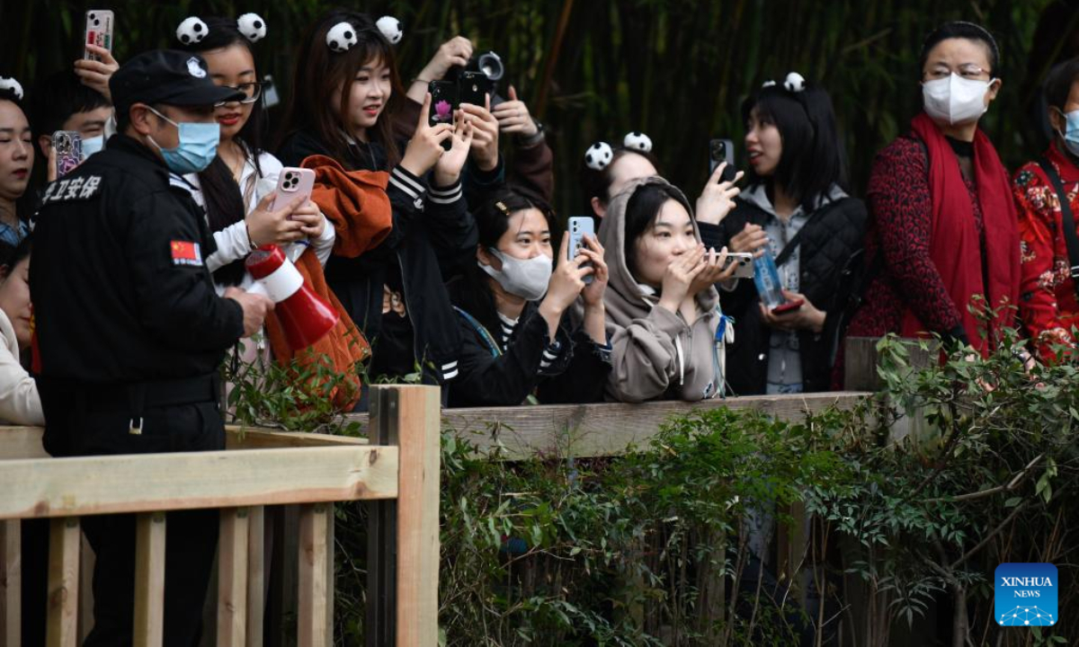 Visitors take pictures at Chengdu Research Base of Giant Panda Breeding in Chengdu, southwest China's Sichuan Province, March 22, 2023. Photo:Xinhua