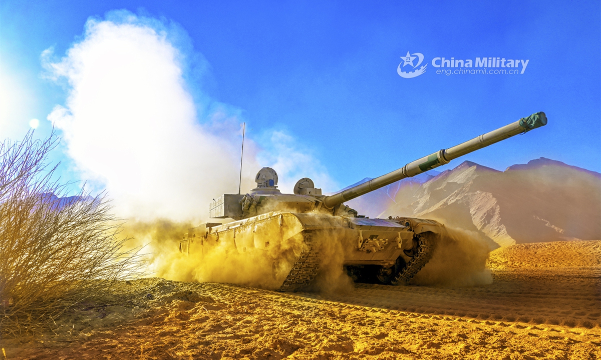 A main battle tank attached to a tank element under the PLA 77th Group Army rumbles through a mound of dust en route to a designated field during a field training exercise in northwest China’s Gobi desert in mid March, 2023. (eng.chinamil.com.cn/Photo by Xue Zongyan and Liu Shanlin)