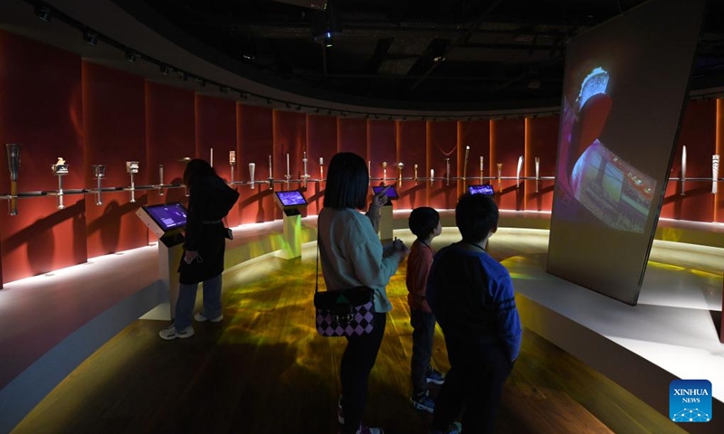People view vedio of moments of the Olympic Games at the International Olympic Museum in Lausanne, Switzerland, March 21, 2023. (Xinhua/Lian Yi)