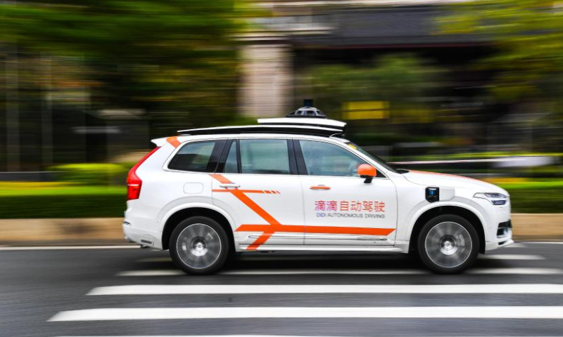 A Didi autonomous driving vehicle runs on a street in Huadu District of Guangzhou, south China's Guangdong Province, March 27, 2023. The first batch of Didi autonomous driving vehicles started commercialized demonstration operation here on Monday. Passengers can place an order to book vehicles in the Didi Robotaxi applet, experience autonomous driving service, and pay according to the actual mileage and duration of use. (Xinhua/Liu Dawei)