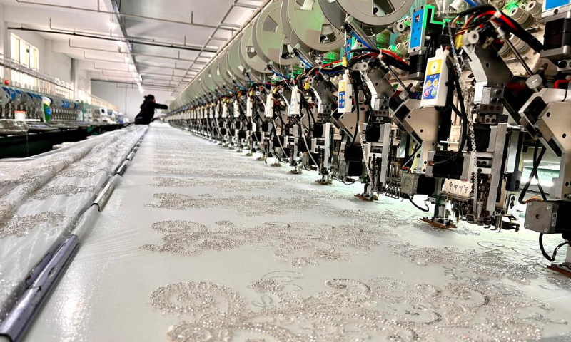 Computerized embroidery machines run in a wedding dress factory in Dingji township, Yu'an district, Lu'an city, East China's Anhui Province. Photo: Xinhua