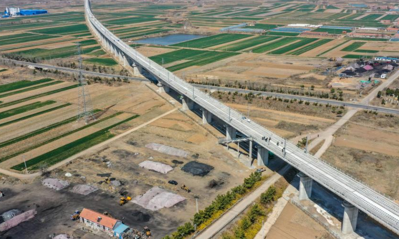 This aerial photo taken on March 31, 2023 shows a grand bridge of the Laixi-Rongcheng high-speed railway in Laixi, east China's Shandong Province. With a designed speed of 350 kilometers per hour, the Laixi-Rongcheng high-speed railway links cities of Laixi and Rongcheng in Shandong. The construction of the line officially entered track-laying phase here Saturday. (Xinhua/Zhu Zheng)