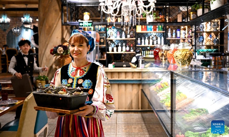 A Russian waitress serves food at a Russian restaurant in Manzhouli, north China's Inner Mongolia Autonomous Region, March 15, 2023. Popularity of Russian goods and foods has revived among local customers after the land port of Manzhouli resumes services. (Xinhua/Bei He)