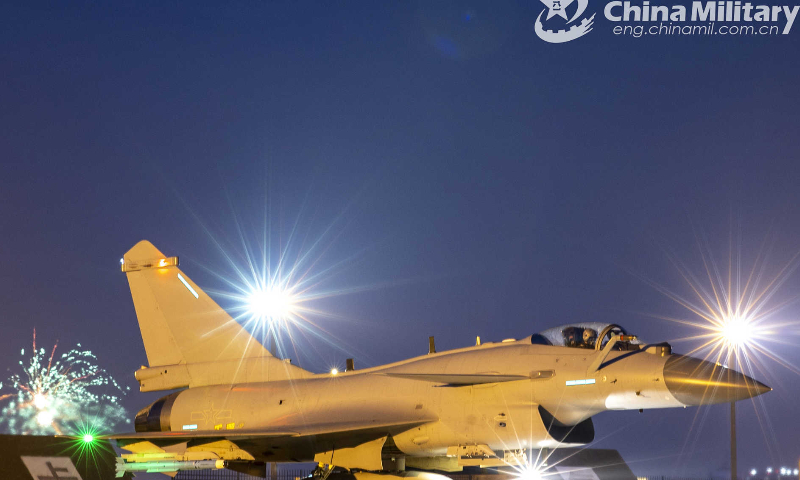 A fighter jet attached to an aviation brigade of the air force under the PLA Southern Theater Command taxies out of the hangar before a recent real combat training exercise. (eng.chinamil.com.cn/Photo by Wang Guoyun)
