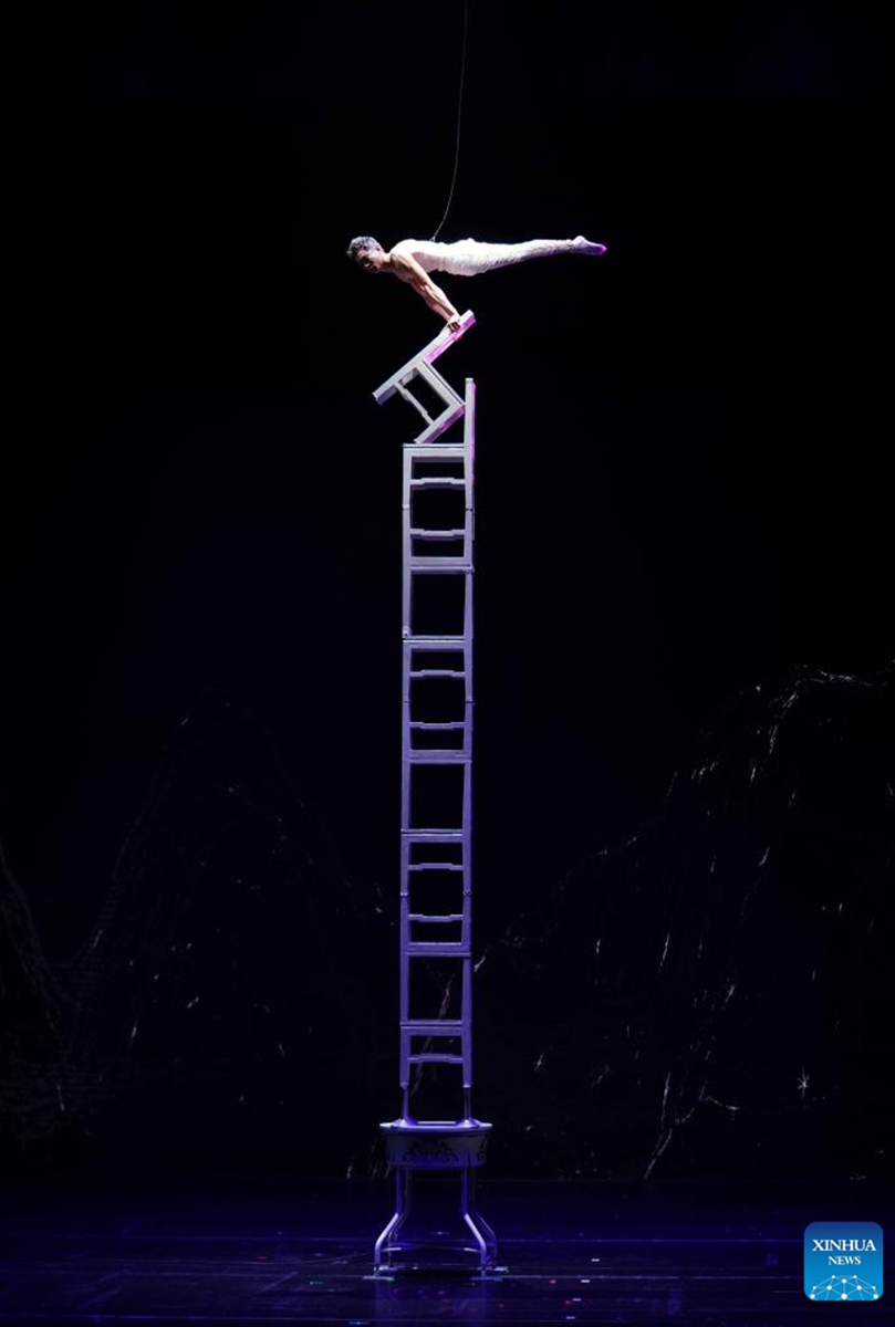 An actor performs on stage at the Shandong Grand Theatre in Jinan, east China's Shandong Province, March 21, 2023. The 11th China Acrobatic Exhibition is held on March 16-29 in Jinan. This year's event features a series of acrobatic and magic shows as well as acrobatic dramas. (Xinhua/Xu Suhui)