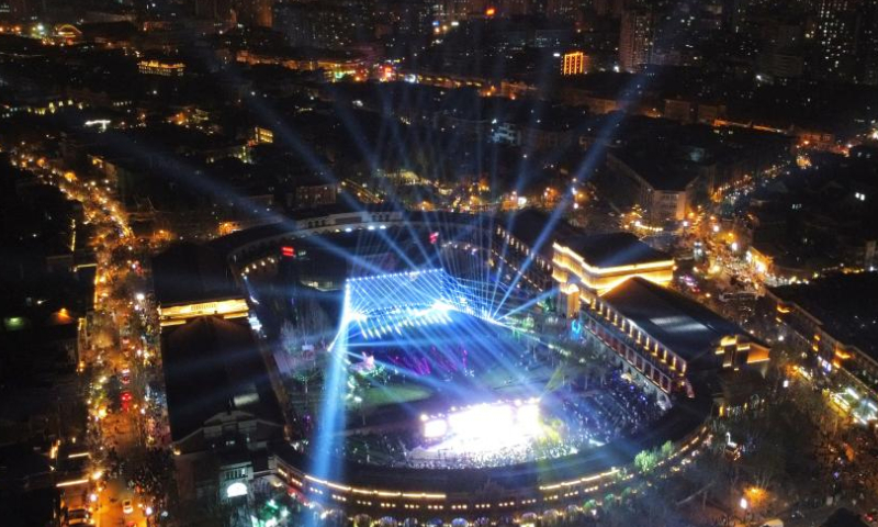 This aerial photo taken on March 31, 2023 shows a light show themed on Chinese flowering crabapple at the Wudadao historical urban area, or the Five Great Avenues, in north China's Tianjin. The Wudadao historical urban area, or the Five Great Avenues, in north China's Tianjin attracted flocks of visitors during the blooming season of Chinese flowering crabapple recently. In order to further embrace the tourism boom brought by the blossoms, Heping District of Tianjin launched a series of events themed on Chinese flowering crabapple from March 31 to April 9, featuring float parade, light show and cultural fair. (Xinhua/Zhao Zishuo)