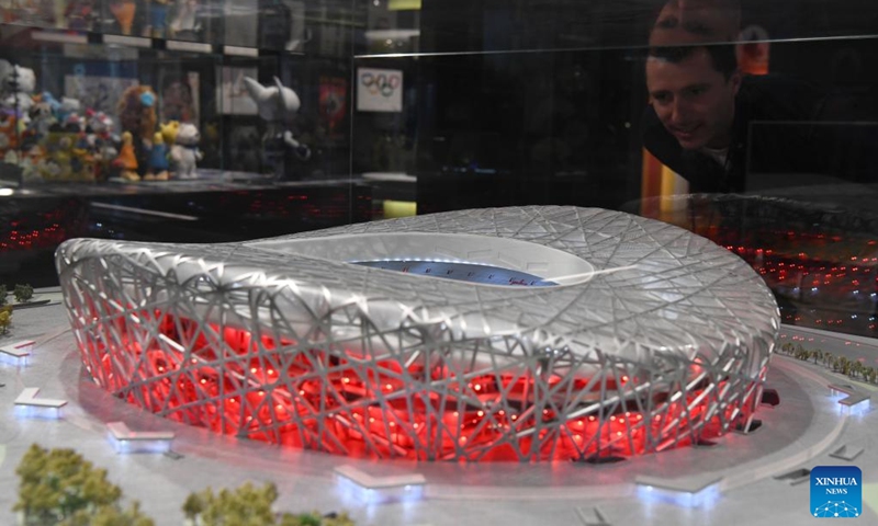 A man looks at a replica of the National Stadium, also known as the Bird's Nest, at the International Olympic Museum in Lausanne, Switzerland, March 21, 2023. (Xinhua/Lian Yi)