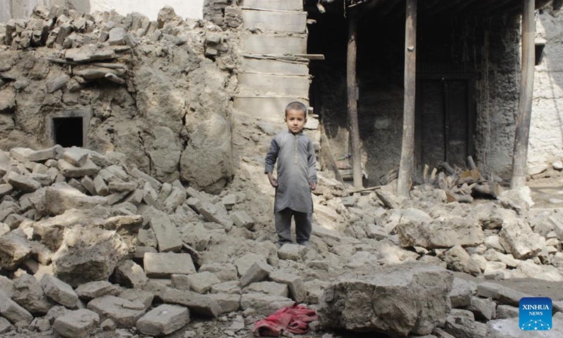 A child stands on the rubble of damaged houses after an earthquake in Laghman province, Afghanistan, March 22, 2023.(Photo: Xinhua)
