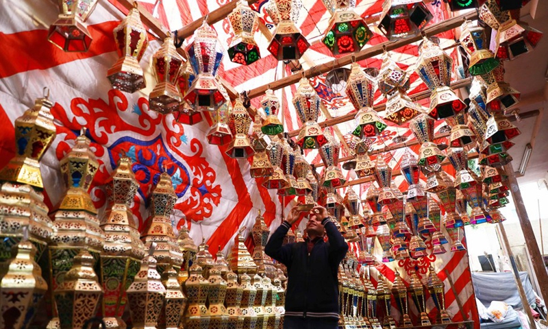 A man takes photos of lanterns ahead of the holy month of Ramadan at a lantern market in Cairo, Egypt, on March 18, 2022. Ahead of the holy month of Ramadan, Egyptians would always flock to local markets to purchase colorful lanterns for their children or to use them as ornaments for homes and workplaces, which has been a centuries-old Egyptian tradition.(Photo: Xinhua)