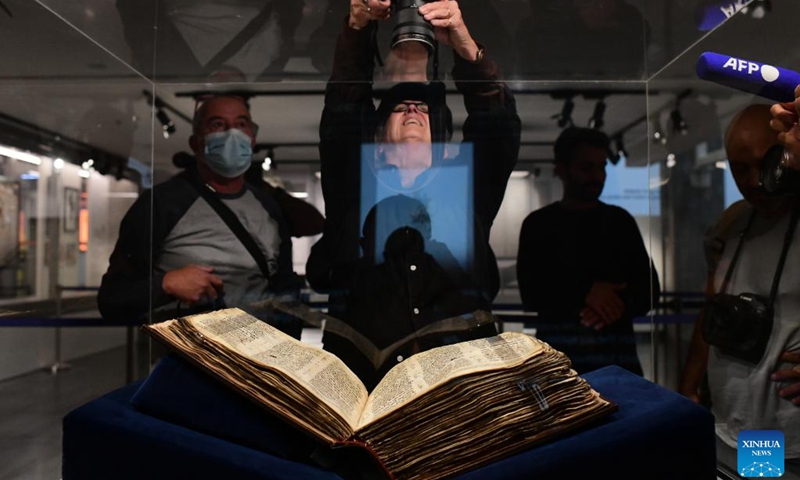 People view the Codex Sassoon at the ANU Museum of the Jewish People in Tel Aviv, Israel, on March 22, 2023. The Codex Sassoon, the oldest-known and the most complete Hebrew Bible manuscript, will be on display for the first time in Israel on Thursday, The Times of Israel has reported.(Photo: Xinhua)