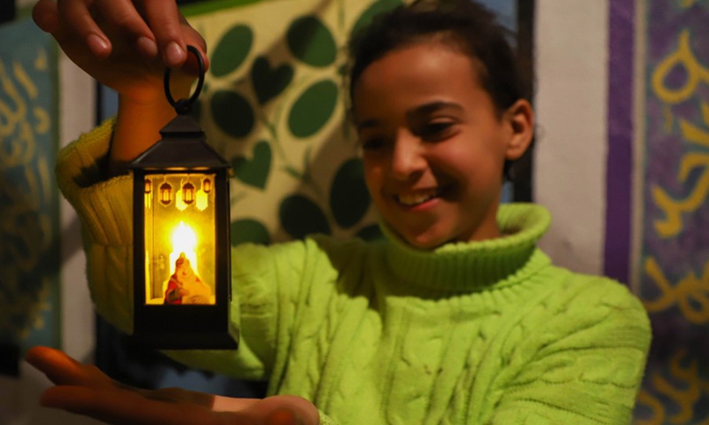 A Palestinian girl holds a lantern to celebrate the upcoming Ramadan, in Gaza City, on March 20, 2023. Palestinians are preparing for the Islamic holy month of Ramadan which falls on Thursday. (Photo: Xinhua)