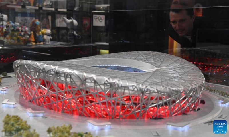 A man looks at a replica of the National Stadium, also known as the Bird's Nest, at the International Olympic Museum in Lausanne, Switzerland, March 21, 2023.(Photo: Xinhua)