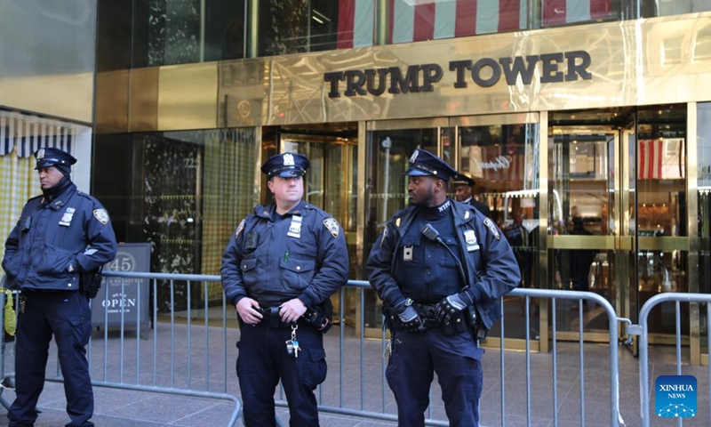 Policemen stand guard in front of Trump Tower in New York, the United States, on March 21, 2023. Law enforcement in New York City stepped up security measures in sensitive areas after former U.S. President Donald Trump recently suggested that he would be arrested on Tuesday and called for his supporters to stage protests.(Photo: Xinhua)
