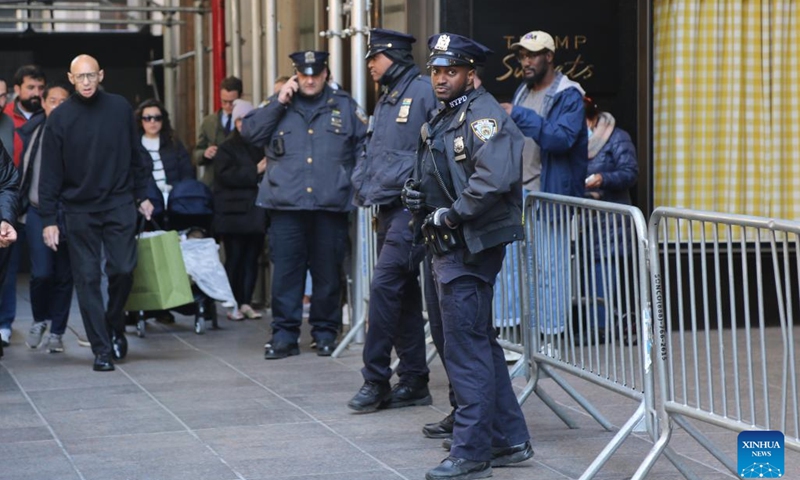 Policemen stand guard in front of Trump Tower in New York, the United States, on March 21, 2023. Law enforcement in New York City stepped up security measures in sensitive areas after former U.S. President Donald Trump recently suggested that he would be arrested on Tuesday and called for his supporters to stage protests.(Photo: Xinhua)