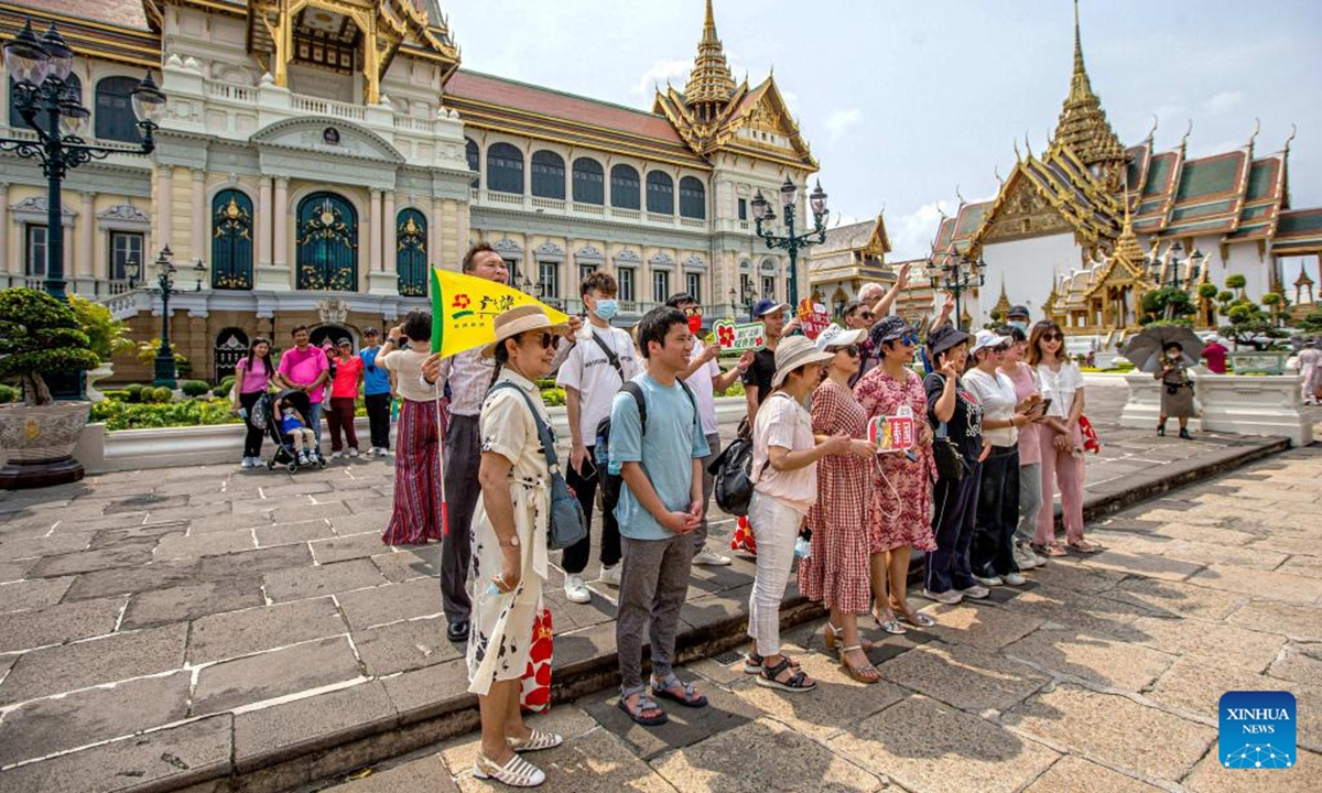 Chinese tourists pose for photos at the Grand Palace scenic spot in Bangkok, Thailand, Feb. 7, 2022. Three years after the pandemic, the first tour groups from China arrived Monday in the Thai capital of Bangkok, greeted by flowers and a warm welcome from the Southeast Asian country betting on tourists' return to boost the recovery of its vital tourism sector. (Xinhua/Wang Teng)