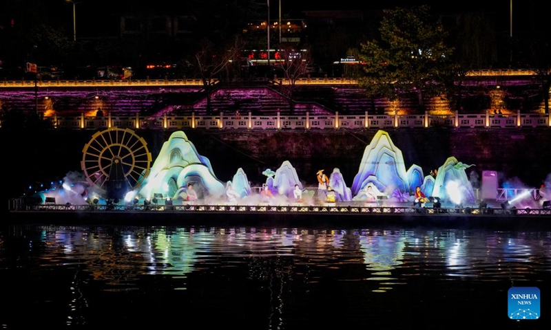 Performers stage a show on Jialing River in Langzhong, southwest China's Sichuan Province, March 21, 2023. In recent years, Langzhong has launched several live performances featuring local cultural elements to enhance tourists' night tour experience and boost the local cultural tourism.(Photo: Xinhua)