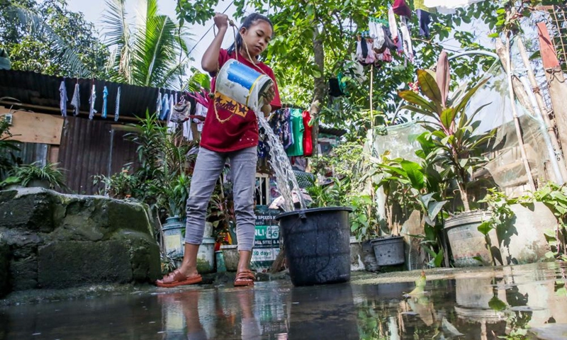 A resident fetches water from a well at a residential area on the occasion of World Water Day in Quezon City, the Philippines, March 22, 2023.(Photo: Xinhua)