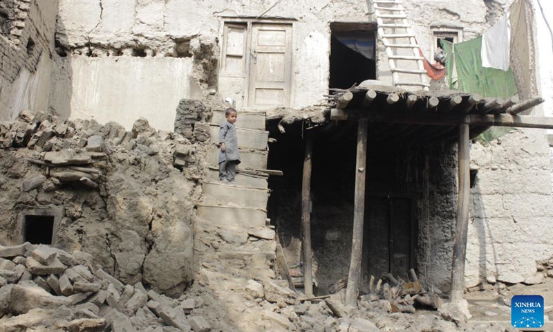 A child stands on the rubble of damaged houses after an earthquake in Laghman province, Afghanistan, March 22, 2023.(Photo: Xinhua)