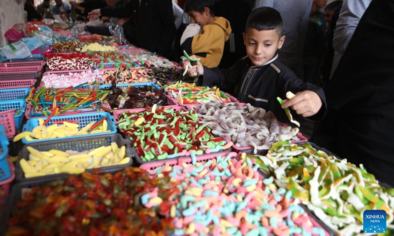A Palestinian boy is seen at a market on the first day of the holy month of Ramadan in the West Bank city of Hebron, on March 23, 2023.(Photo: Xinhua)