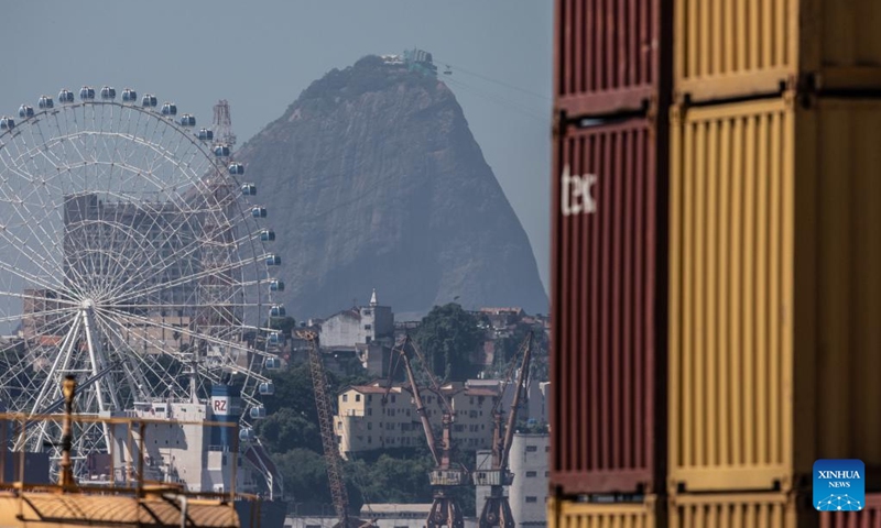 The ferris wheel Rio Star and the Sugarloaf Mountain are pictured from a container terminal at Rio de Janeiro Port in Brazil, March 20, 2023. Established in the early 20th century, Rio de Janeiro Port is one of the important seaports for goods import and export in Brazil, playing a significant role in the country's economic and trade development. (Xinhua/Wang Tiancong)