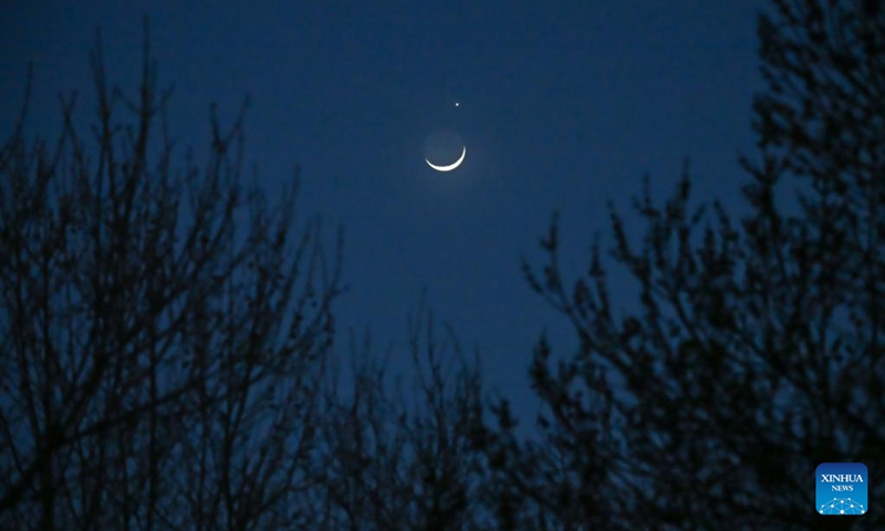 The planet Venus and the crescent moon are pictured in Beijing, capital of China, March 24, 2023. (Xinhua/Li Xin)