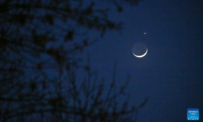 The planet Venus and the crescent moon are pictured in Beijing, capital of China, March 24, 2023. (Xinhua/Li Xin)