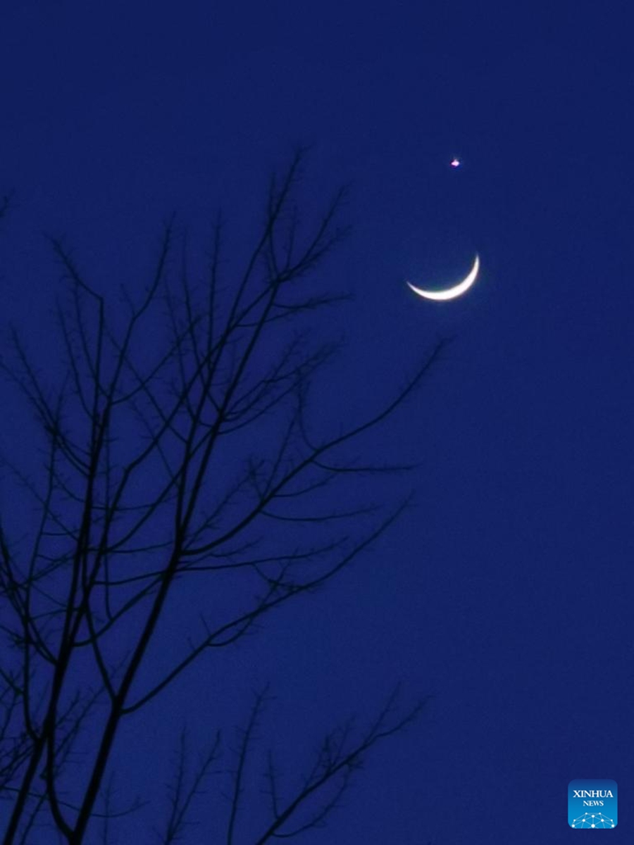 This photo taken with a mobile phone shows the planet Venus and the crescent moon in Beijing, capital of China, March 24, 2023. (Xinhua/Luo Xiaoguang)