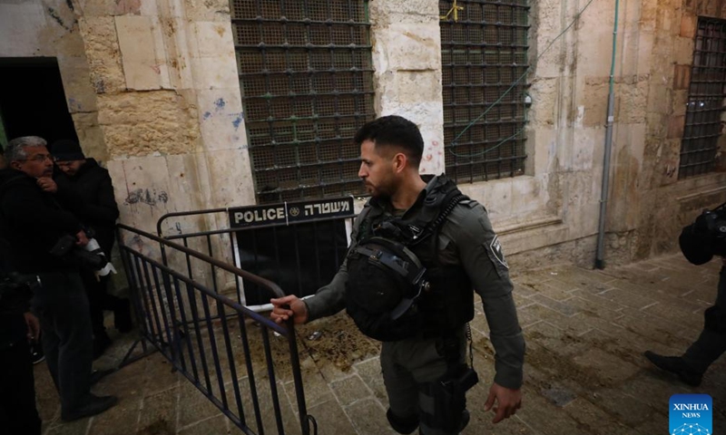 An Israeli police officer stands guard after a reported shooting incident at the Al-Aqsa Mosque compound in Jerusalem, April 1, 2023. Earlier on Saturday, a Palestinian man was shot dead by Israeli police forces at the entrance to the Al-Aqsa mosque compound in Jerusalem. The police said the man attempted to carry out an attack against the forces, which was rejected by some Palestinians at the scene. (Photo by Muammar Awad/Xinhua)