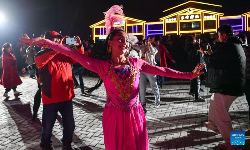Villagers dance in traditional costumes in Bahrigzi Village of Tar Tajik Township, Akto County, northwest China's Xinjiang Uygur Autonomous Region, March 27, 2023. Tar Tajik Township, nestled in the hinterland of the Kunlun Mountains, is a key national rural tourism village under Akto County, northwest China's Xinjiang Uygur Autonomous Region. As the weather gets warmer, apricot flowers are in full bloom here. The magnificent natural scenery and unique folk customs attract many tourists.(Photo: Xinhua)