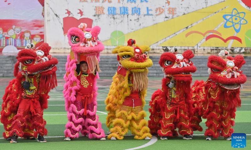 Children prepare to practice lion dance at a kindergarten in Tengxian County of Wuzhou, south China's Guangxi Zhuang Autonomous Region, March 28, 2023. The Tengxian Lion Dance, which is listed as a national intangible cultural heritage, is a combination of martial arts, dancing, music and acrobatics. In recent years, Tengxian County has been actively integrating the lion dance with courses in kindergartens and schools, with the goal of passing on this traditional art form to younger generations.(Photo: Xinhua)