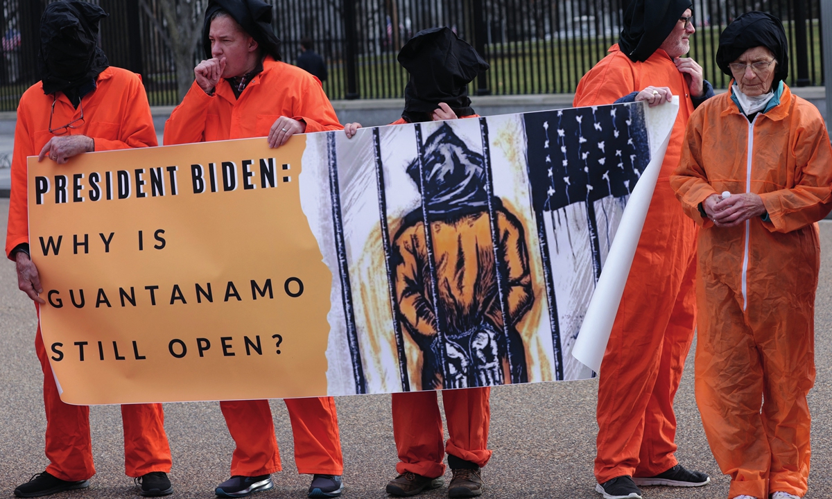 Activists in orange jumpsuits, representing the 35 men who are still being held at the US detention facility in Guantanamo Bay, Cuba, protest in front of the White House on January 11, 2023 in Washington, DC. Photo: AFP