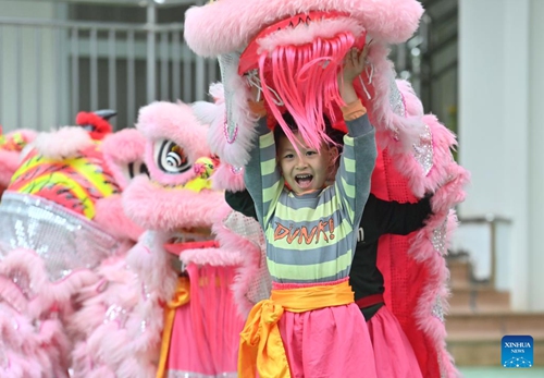 Children practice lion dance at a kindergarten in Tengxian County of Wuzhou, south China's Guangxi Zhuang Autonomous Region, March 28, 2023. The Tengxian Lion Dance, which is listed as a national intangible cultural heritage, is a combination of martial arts, dancing, music and acrobatics. In recent years, Tengxian County has been actively integrating the lion dance with courses in kindergartens and schools, with the goal of passing on this traditional art form to younger generations.(Photo: Xinhua)