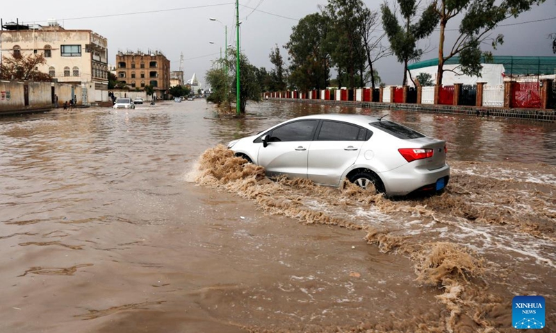 A car is seen driving through a flooded street after torrential rain in Sanaa, Yemen, March 29, 2023.(Photo: Xinhua)