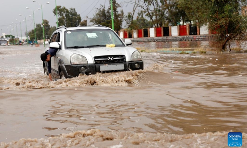 A car is seen driving through a flooded street after torrential rain in Sanaa, Yemen, March 29, 2023.(Photo: Xinhua)