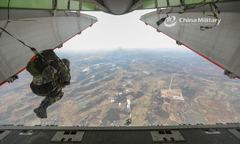 Airmen assigned to an airborne brigade of the PLA Air Force jump out of the aircraft during a parachuting training exercise on March 25, 2023. (eng.chinamil.com.cn/Photo by Zhu Haitao)