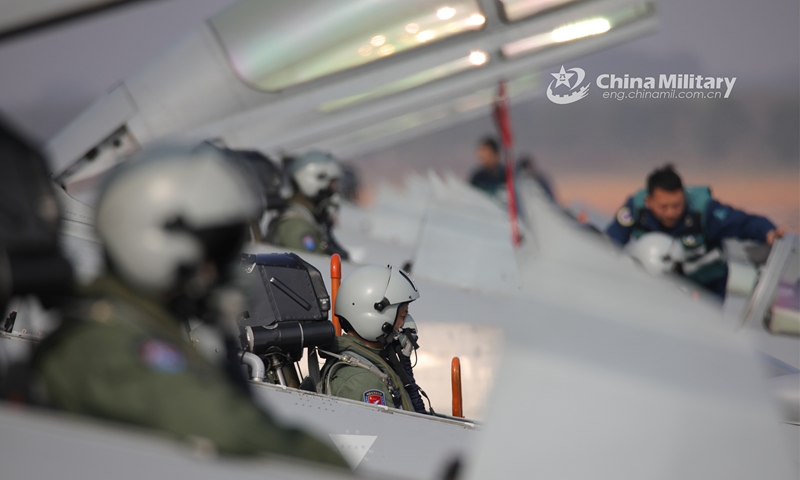 Fighter jets attached to an aviation brigade of the air force under the PLA Southern Theater Command receive pre-flight inspections before taking off during a day-and-night flight training exercise on March 11, 2023. (eng.chinamil.com.cn/Photo by Hao Hunan)