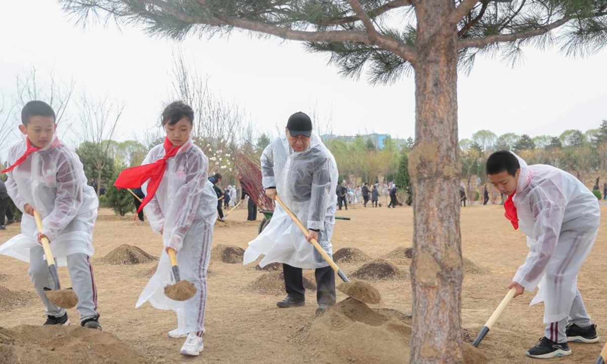 Chinese President Xi Jinping, also general secretary of the Communist Party of China Central Committee and chairman of the Central Military Commission, plants a tree during a voluntary tree planting activity in Beijing, capital of China, April 4, 2023. Xi and other leaders, including Li Qiang, Zhao Leji, Wang Huning, Cai Qi, Ding Xuexiang, Li Xi, and Han Zheng, planted trees with local people at a city park in the eastern district of Chaoyang in the spring shower. (Xinhua)