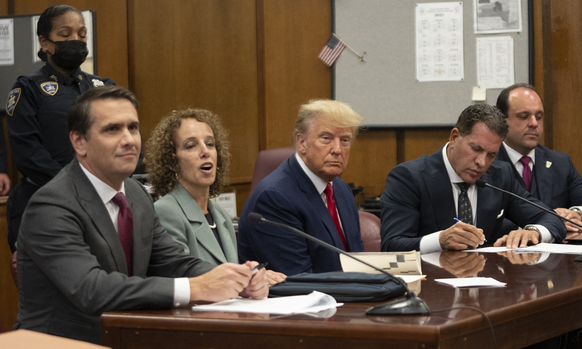 Former US president Donald Trump (center) appears in court at the Manhattan Criminal Court in New York on April 4, 2023. Trump was charged with 34 felony counts of falsifying business records, prosecutors said. The usually vocal Trump was mostly silent through the routine proceedings — except to tell Judge Juan Merchan in a firm voice: 