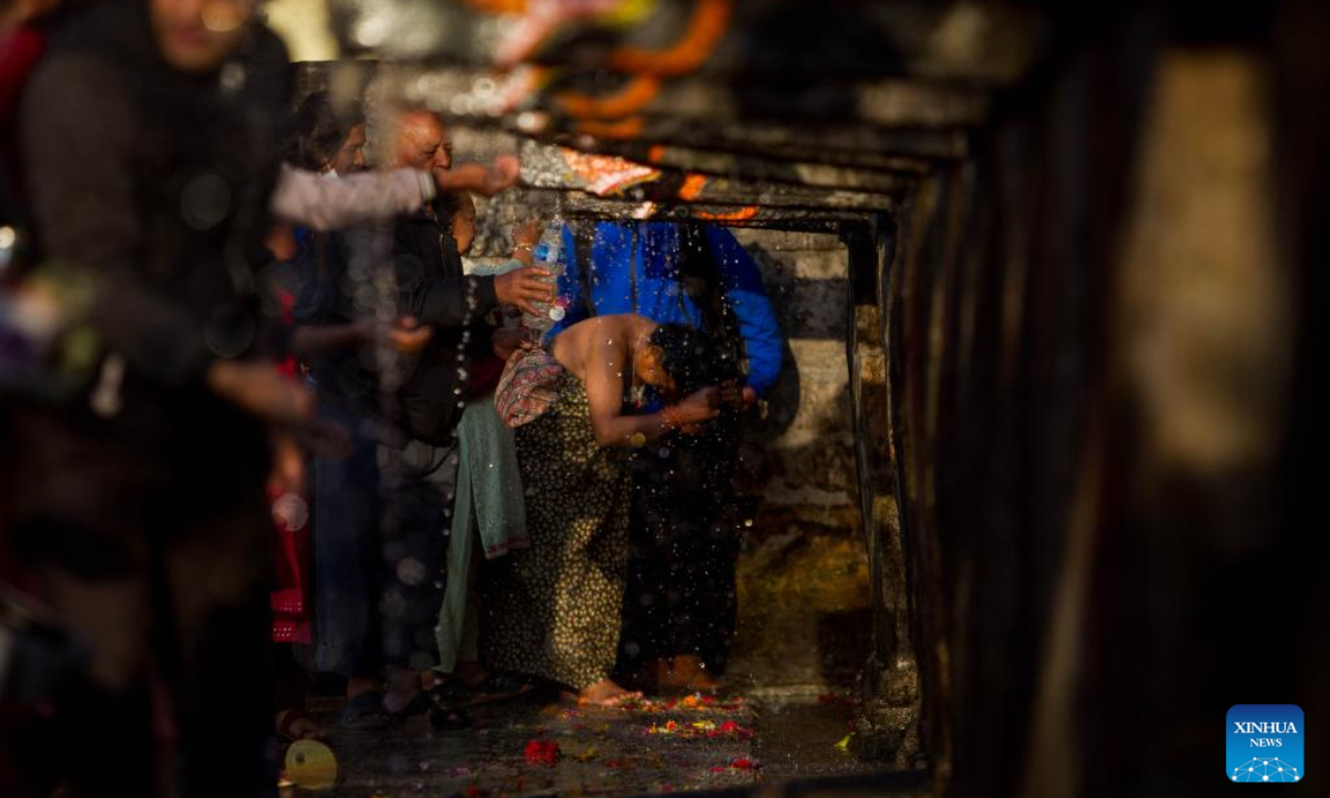 A woman takes a holy bath during the Baishak Asnan festival in Kathmandu, Nepal, April 6, 2023. The locals believe that taking a holy bath on this day purifies one's spirit and makes one free from skin diseases. Photo:Xinhua