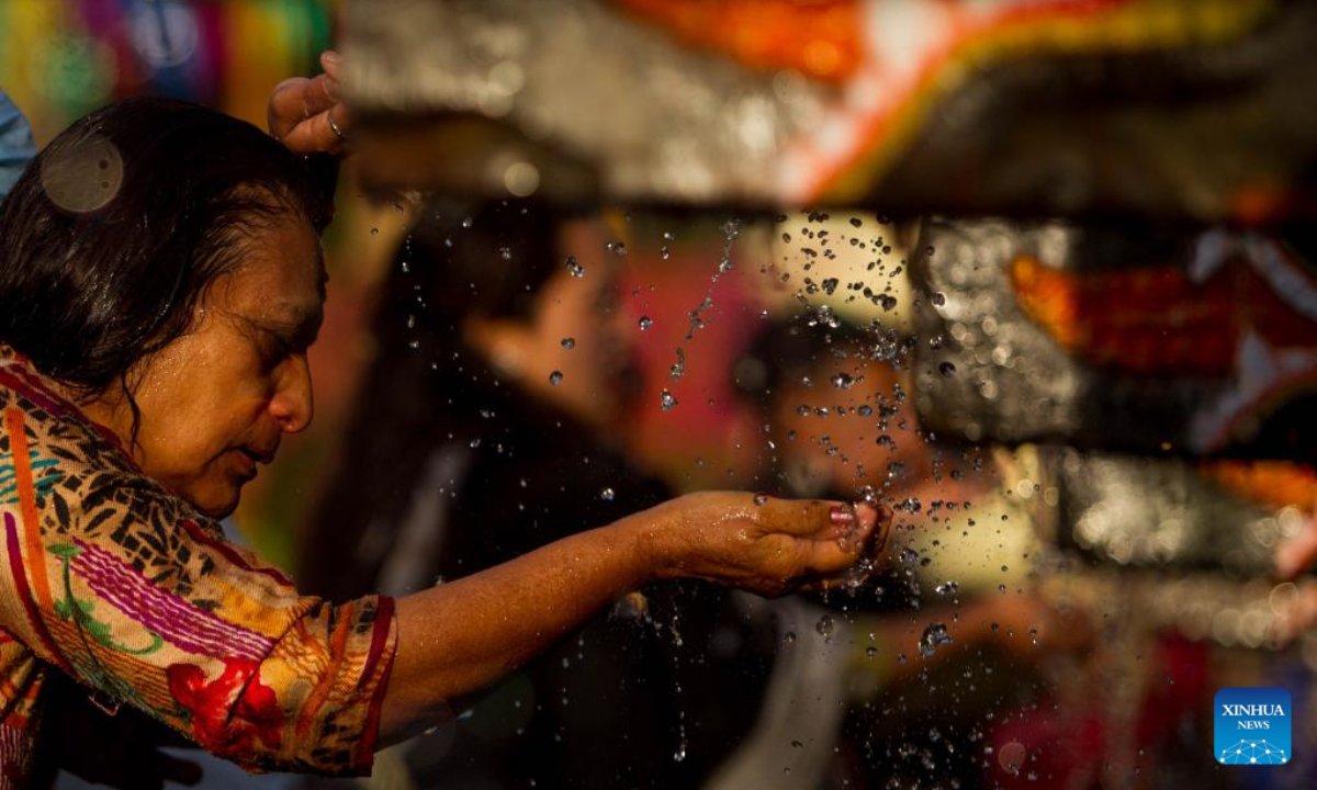 A woman takes a holy bath during the Baishak Asnan festival in Kathmandu, Nepal, April 6, 2023. The locals believe that taking a holy bath on this day purifies one's spirit and makes one free from skin diseases. Photo:Xinhua