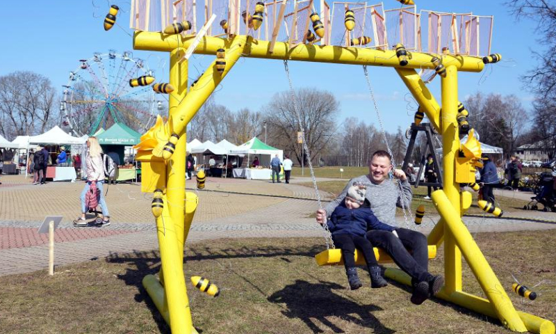 People enjoy themselves during the Swing festival in Sigulda, Latvia, April 8, 2023. Many specially designed swings have been erected for the Swing festival in Sigulda. (Photo by Edijs Palens/Xinhua)