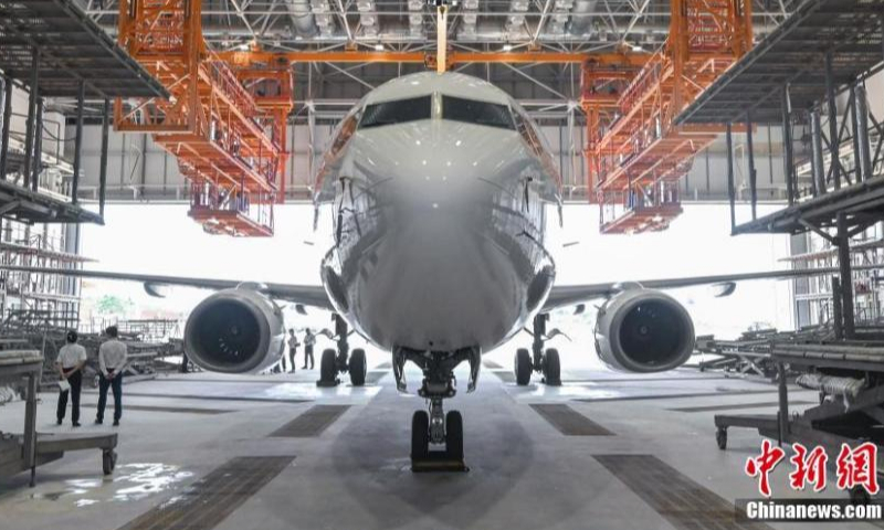 A Boeing 737-800CF aircraft is painted at the One-stop Aircraft Maintenance Industry Base of Hainan Free Trade port in Haikou, south China's Hainan Province, April 6, 2023. (Photo: China News Service/Luo Yunfei)

The Hainan Free Trade Port offered preferential tax exemptions for maintenance of aviation materials.