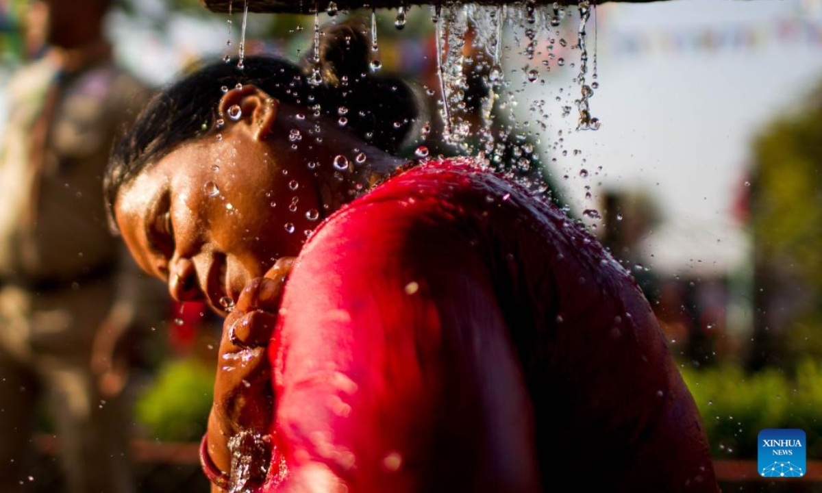 A woman takes a holy bath during the Baishak Asnan festival in Kathmandu, Nepal, April 6, 2023. The locals believe that taking a holy bath on this day purifies one's spirit and makes one free from skin diseases. Photo:Xinhua