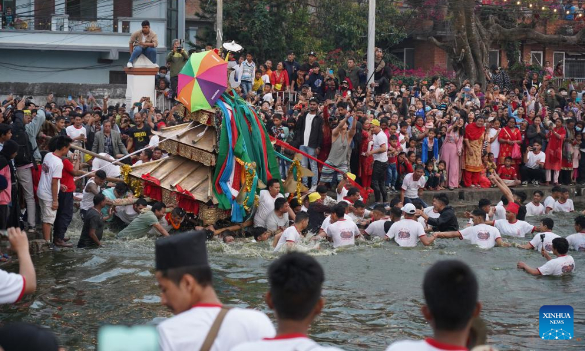 Local people carry on their shoulders a chariot of Goddess Tundaldevi in search for her lost jewellery in a 