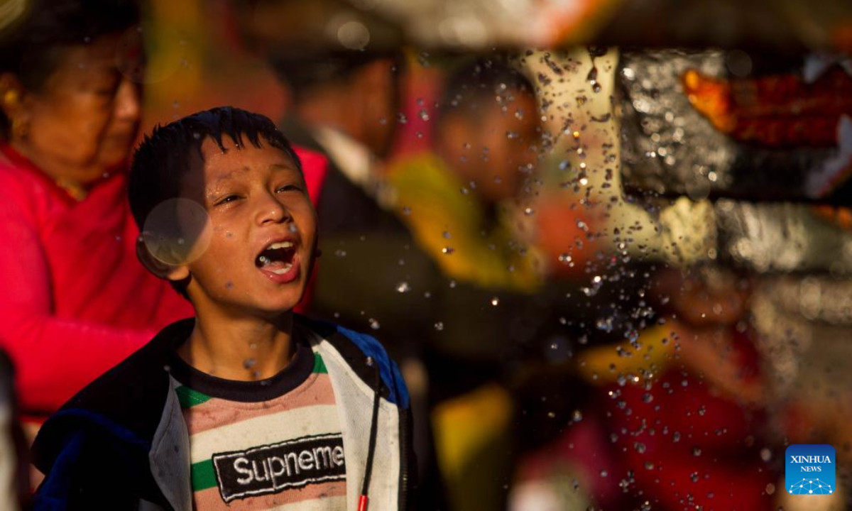 A boy takes a holy bath during the Baishak Asnan festival in Kathmandu, Nepal, April 6, 2023. The locals believe that taking a holy bath on this day purifies one's spirit and makes one free from skin diseases. Photo:Xinhua