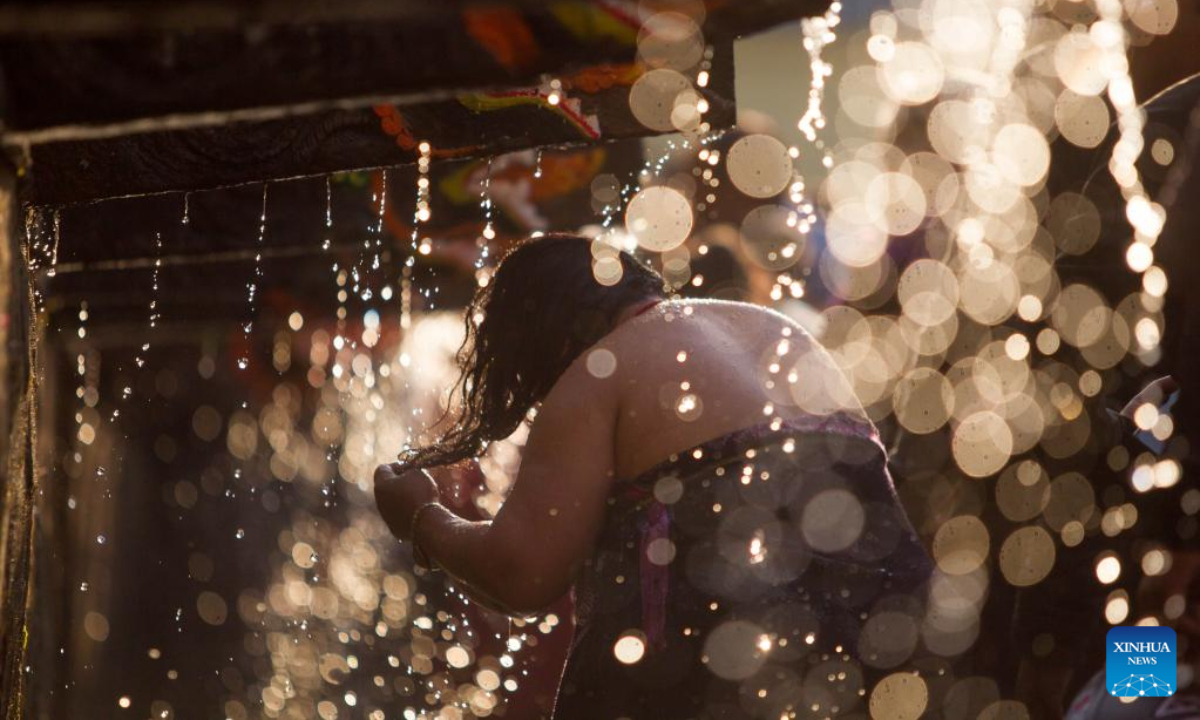 A woman takes a holy bath during the Baishak Asnan festival in Kathmandu, Nepal, April 6, 2023. The locals believe that taking a holy bath on this day purifies one's spirit and makes one free from skin diseases. Photo:Xinhua