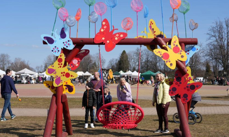 People attend the Swing festival in Sigulda, Latvia, April 8, 2023. Many specially designed swings have been erected for the Swing festival in Sigulda. (Photo by Edijs Palens/Xinhua)