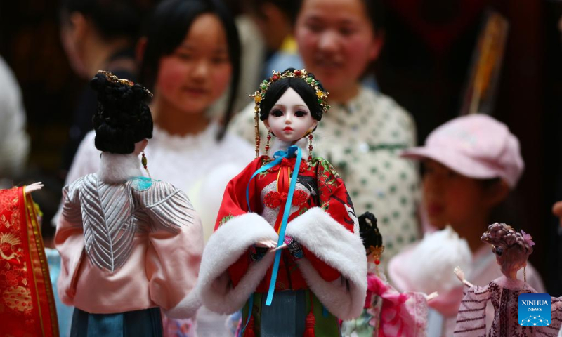 Dolls are seen on a fair in Tengzhou City, east China's Shandong Province, May 2, 2023. China is witnessing a travel boom during this year's five-day May Day holiday. (Photo by Li Zhijun/Xinhua)
