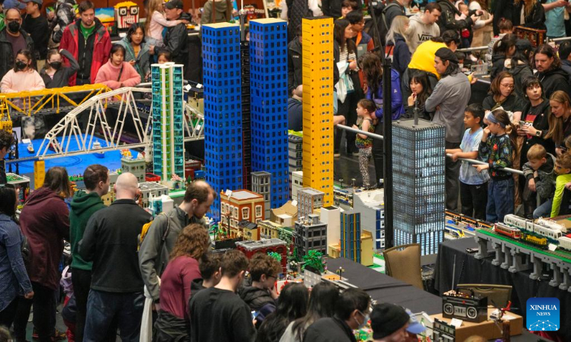 People look at the LEGO installations displayed at the BrickCan LEGO exhibition at the River Rock Theatre in Richmond, British Columbia, Canada, on April 22, 2023. Over 300 LEGO builders from around the world showcased their creations at BrickCan 2023, which was held here in Richmond between April 22 and 23. (Photo by Liang Sen/Xinhua)